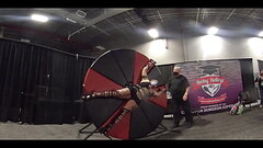 Blonde Lady on a spinning wheel at EXXXotica NJ 2021 NJ in 360 degree VR Thumb